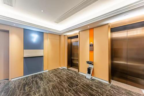 a hallway with elevators in a building at Holiday Inn Express Hangzhou Qianjiang CenturyCity by IHG in Hangzhou