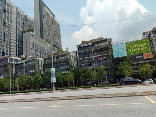 an empty street with tall buildings in a city at MD Home in Cyberjaya