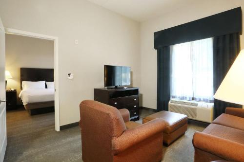 a hotel room with a bed and a living room at Homewood Suites by Hilton Bel Air in Riverside
