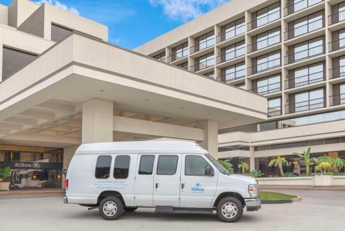 a white van parked in front of a building at Hilton Orange County/Costa Mesa in Costa Mesa