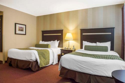 a hotel room with two beds in a room at Quality Inn and Conference Centre in Pembroke