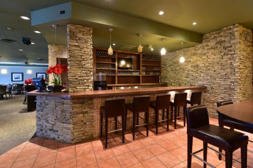 a bar in a restaurant with a stone wall at Quality Inn and Conference Centre in Pembroke
