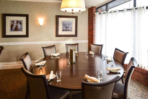 a conference room with a wooden table and chairs at Quality Inn and Conference Centre in Pembroke