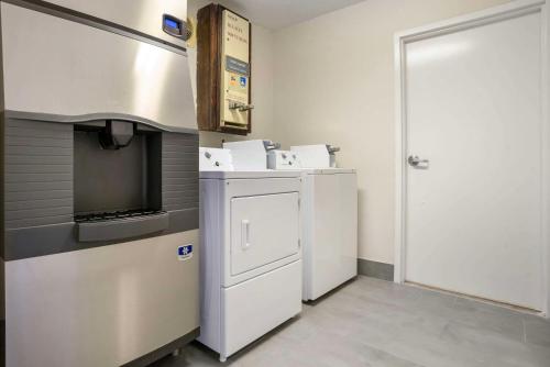 a kitchen with a white refrigerator and a tv at Comfort Inn Livingston in Livingston