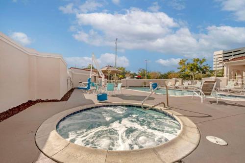 a hot tub on a patio next to a pool at Comfort Suites Downtown in Orlando