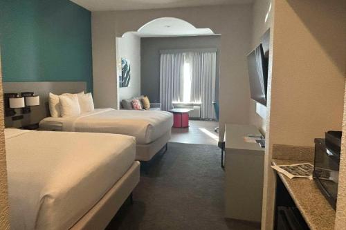 a hotel room with two beds and a television at Comfort Inn & Suites Burnet in Burnet