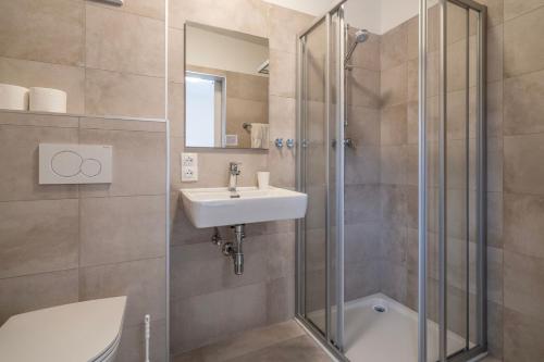 a bathroom with a sink and a shower at Wellness Landhaus Parth in Ossiach