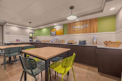 a dining area with tables and chairs in a cafeteria at Spark by Hilton Clarks Summit in Clarks Summit