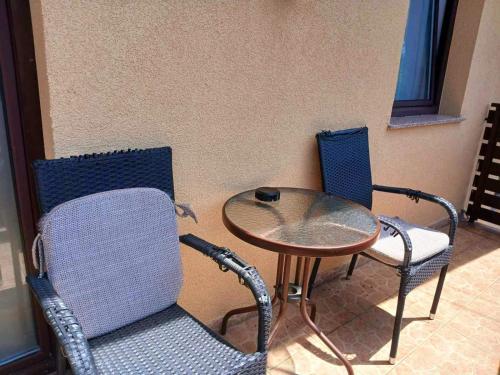 two chairs and a table and a table and chairs at Provence rooms in Banja Luka