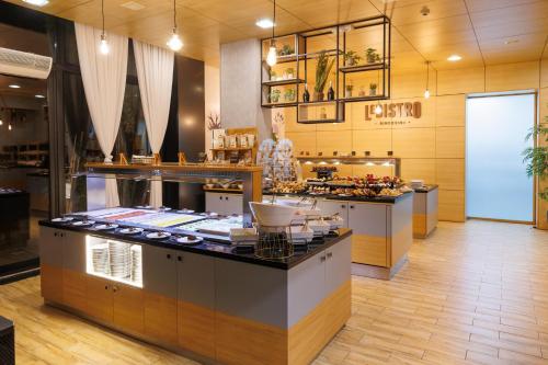 a restaurant with a counter in the middle of a room at Lucky Bansko Aparthotel SPA & Relax in Bansko