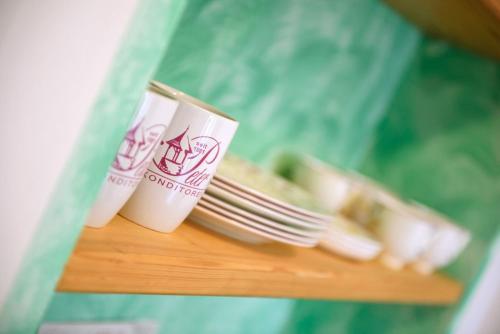 two cups of coffee and plates of food on a table at Peter Paul Studio Buchwald in Appiano Sulla Strada Del Vino