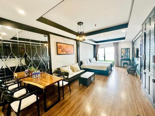 a living room with a couch and a table at TMS Quy Nhơn Sea View in Quy Nhon