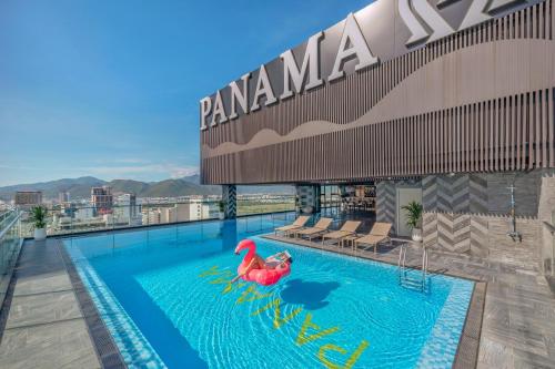 a pool on the roof of a hotel with alatable flamingo at PANAMA Nha Trang Hotel in Nha Trang