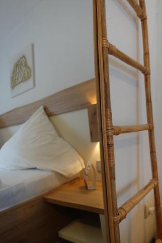 a bedroom with a bunk bed with a ladder next to a bed gmaxwell gmaxwell gmaxwell at Hotel Berghof Wasserkuppe & Gästehaus Fuldaquelle in Gersfeld