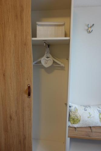 a door to a room with a bed and a shelf at Hotel Berghof Wasserkuppe & Gästehaus Fuldaquelle in Gersfeld