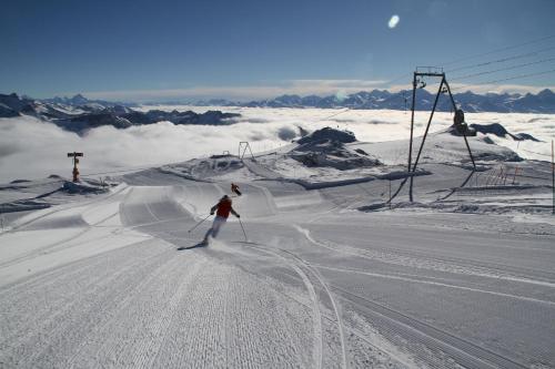 a person is skiing down a snow covered slope at Chalet Hubel in Gstaad