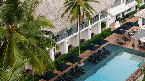 an overhead view of a hotel with a pool and palm trees at Souphattra Hotel Luang Prabang in Luang Prabang