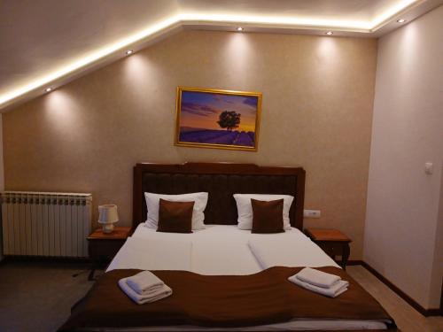a bedroom with a bed with two towels on it at Provence rooms in Banja Luka