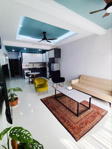 a living room with a couch and a table at Regency Tanjung Tuan - Idealhub in Port Dickson
