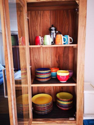 a cabinet filled with bowls and plates at Vollmond -406- in Ahrn