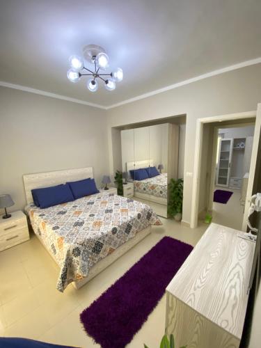 a bedroom with two beds and a large mirror at Aurora Al Sheikh Zayed in Sheikh Zayed
