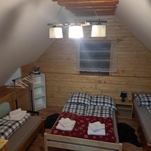 a room with two beds and a table in it at Drevenica Emma in Oravská Polhora
