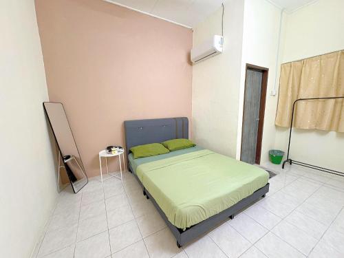 a small bedroom with a bed in a room at Taiping Homestay Near Lakegarden in Taiping