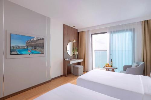 a hotel room with a bed and a pool at PANAMA Nha Trang Hotel in Nha Trang