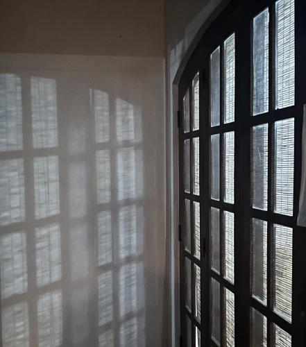 an open window with sunlight coming through it at Bellissimo Escape in Elpitiya