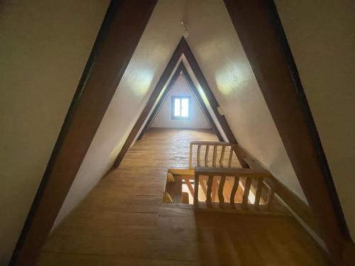 a room with a staircase and a window in a attic at Jai Hidden Paradise in Romblon