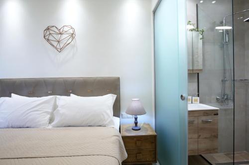 a bedroom with a bed with a heart on the wall at Villas Goudis in Tsoukaladhes