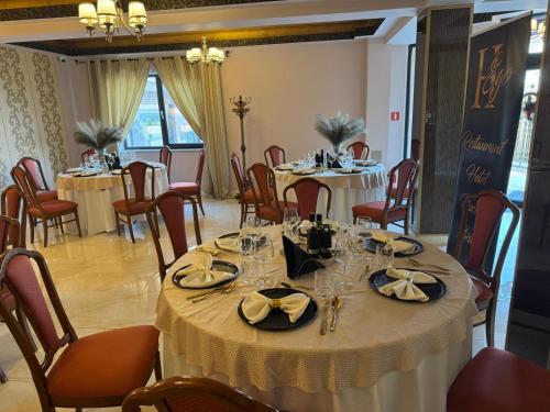 a dining room with round tables and chairs at HEgo in Hunedoara