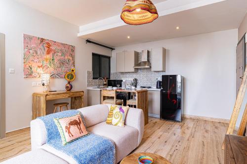 a living room with a couch and a kitchen at Elite One Bedroom Apartment Westlands, Swimming pool, gym, workspace ,Wonderiss Properties close proximity to GTC, JW Mariott and Kempinski in Nairobi