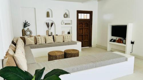 a living room with a couch and a tv at K1 by Ceilao villas in Ahangama