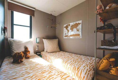 Cama o camas de una habitación en Verblijfpark Tulderheyde