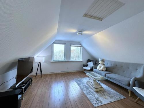 a living room with a couch and a teddy bear at Cozy Coastal Home in Egernsund in Egernsund