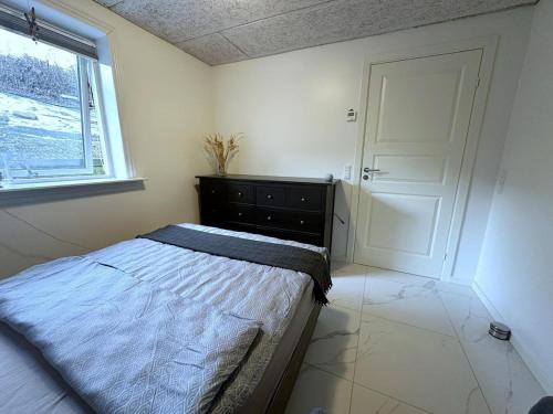 a bedroom with a bed and a window and a door at Cozy Coastal Home in Egernsund in Egernsund