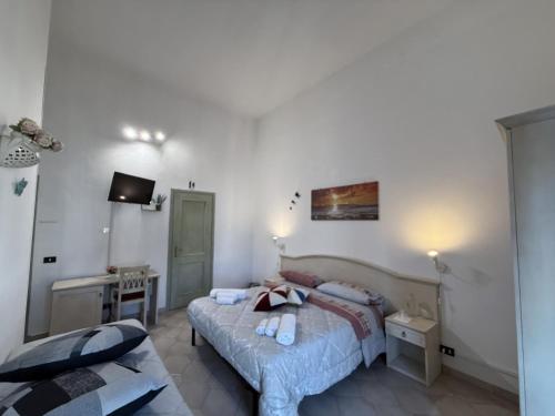 a bedroom with two beds and a television in it at Bed and Breakfast Station in Brindisi