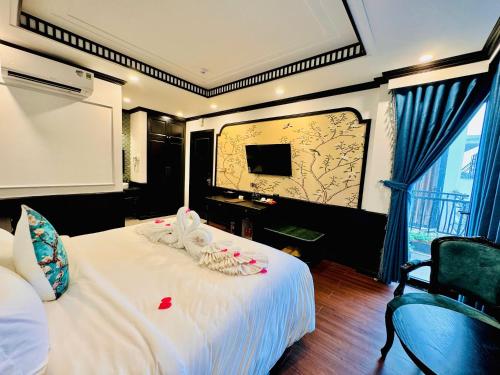 a hotel room with a bed and a tv at The ORCHID PREMIUM Hotel in Hue