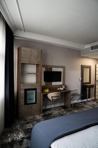 a hotel room with a bed and a desk at saffari otel in Ankara