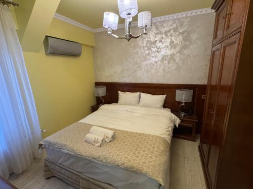 a bedroom with a bed with two towels on it at HEgo in Hunedoara