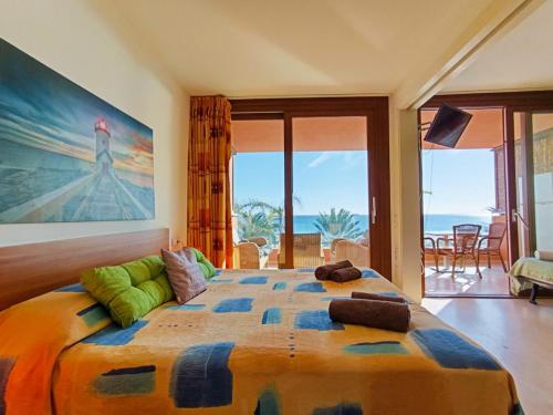 a bedroom with a large bed with a view of the ocean at Apart Ibiza Close to Hi & Ushuaia SEA FRONT in Illes Balears