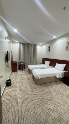 Postel nebo postele na pokoji v ubytování Kol Alayam Hotel