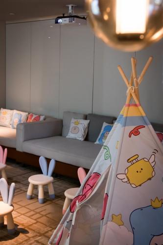 a room with a couch and a bed and chairs at Crowne Plaza Shenzhen World Exhibition and Convention Center by IHG in Shenzhen