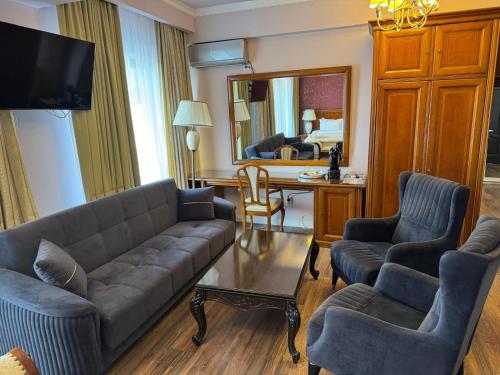 a living room with a couch and chairs and a table at HEgo in Hunedoara