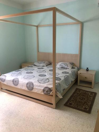 a bed with a canopy in a bedroom at Villa Walegh in Ouallarh