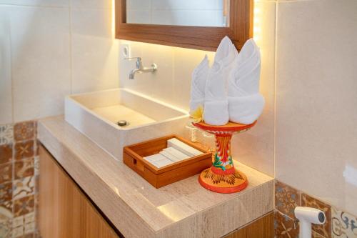 a bathroom with a sink and a wooden box at Kubu GWK Villa in Jimbaran