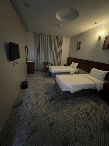 Postel nebo postele na pokoji v ubytování Kol Alayam Hotel