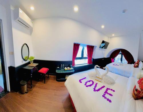 a hotel room with two beds with aprus sign on it at The ORCHID PREMIUM Hotel in Hue