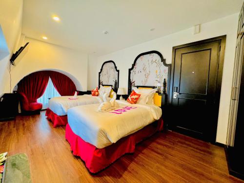 a bedroom with two beds in a room at The ORCHID PREMIUM Hotel in Hue